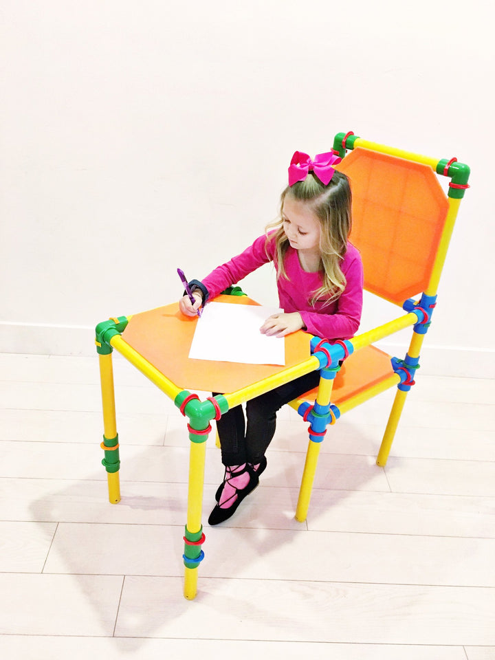 girl playing on building toy furniture